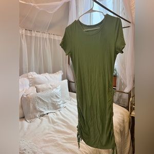Green T-shirt dress with ruching and ties on sides